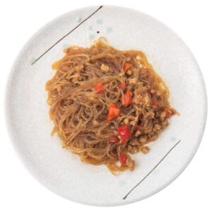piatto bianco con spaghetti di soia con carne piccante
